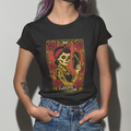 A person wearing a black crew neck t-shirt with a graphic design of a skeleton and the text 'La Más Chingona'. The design includes red and yellow details and rose illustrations.