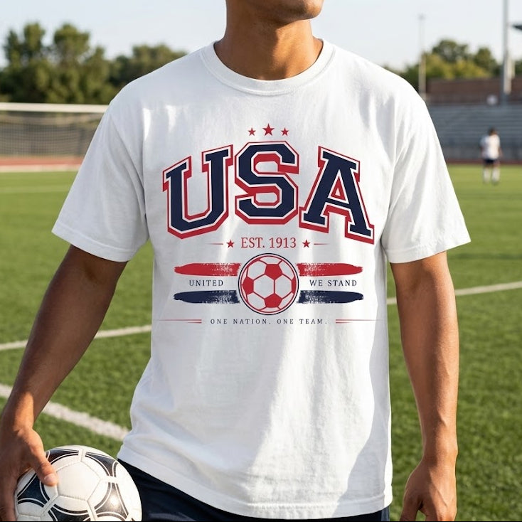 Person wearing a white 'USA' t-shirt on a soccer field
