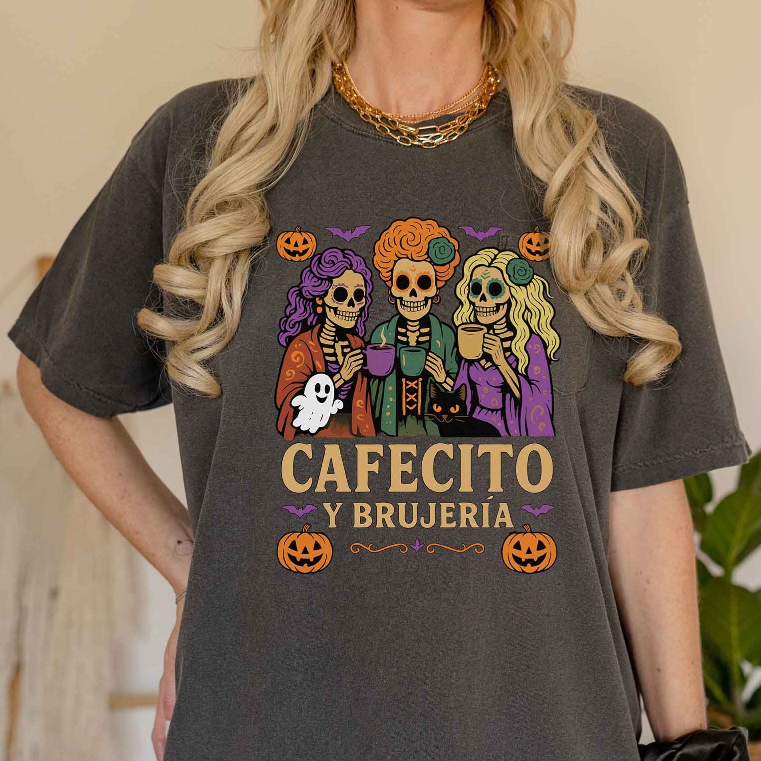 Person wearing a dark gray t-shirt with Halloween-themed graphics and text.