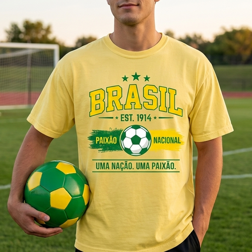 Person wearing a yellow 'Brásíl' t-shirt holding a soccer ball on a sports field.