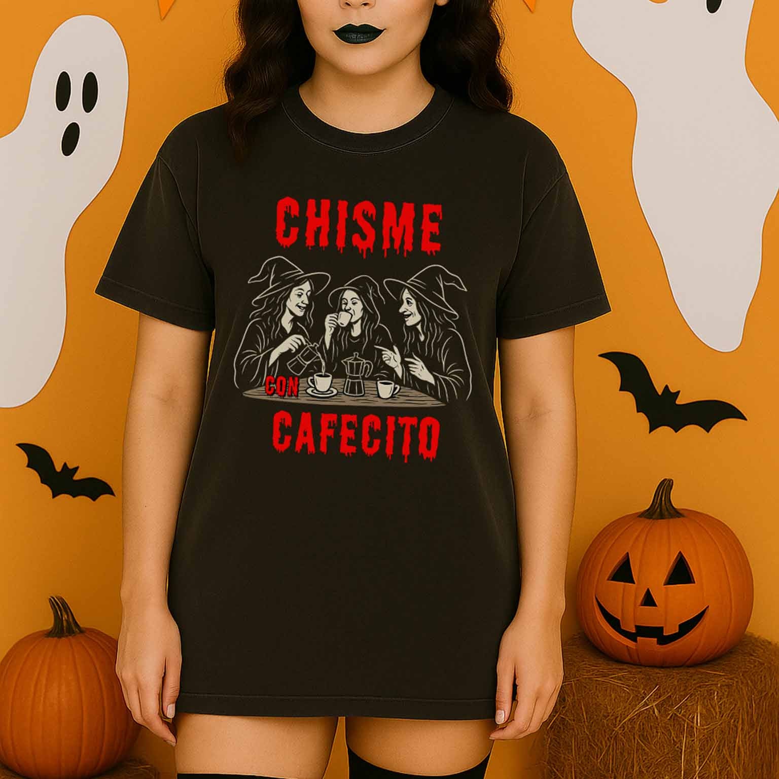 Woman wearing a black t-shirt with Halloween-themed graphics and text, standing in front of a festive background with pumpkins and ghosts.