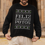 Man wearing a black sweater with 'Feliz Navidad Putos' text in front of an architectural background