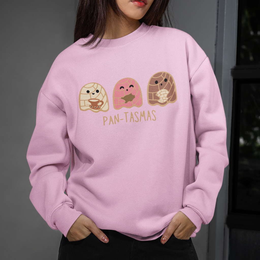 Person wearing a pink sweatshirt with cartoon characters and text, standing indoors.